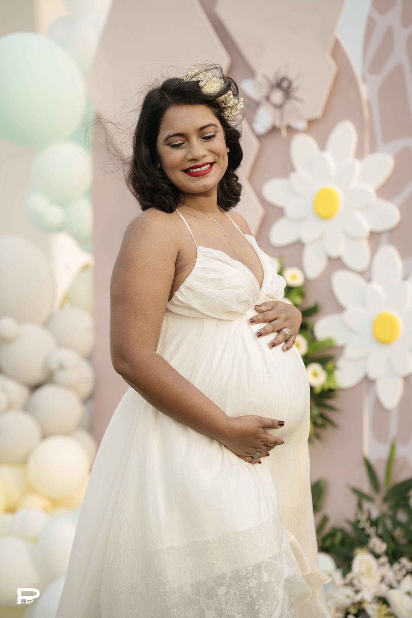 Expecting mother in an elegant white maternity portrait