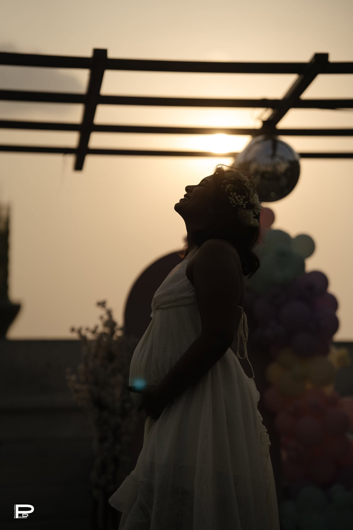 Expecting mother in a glowing sunset maternity portrait