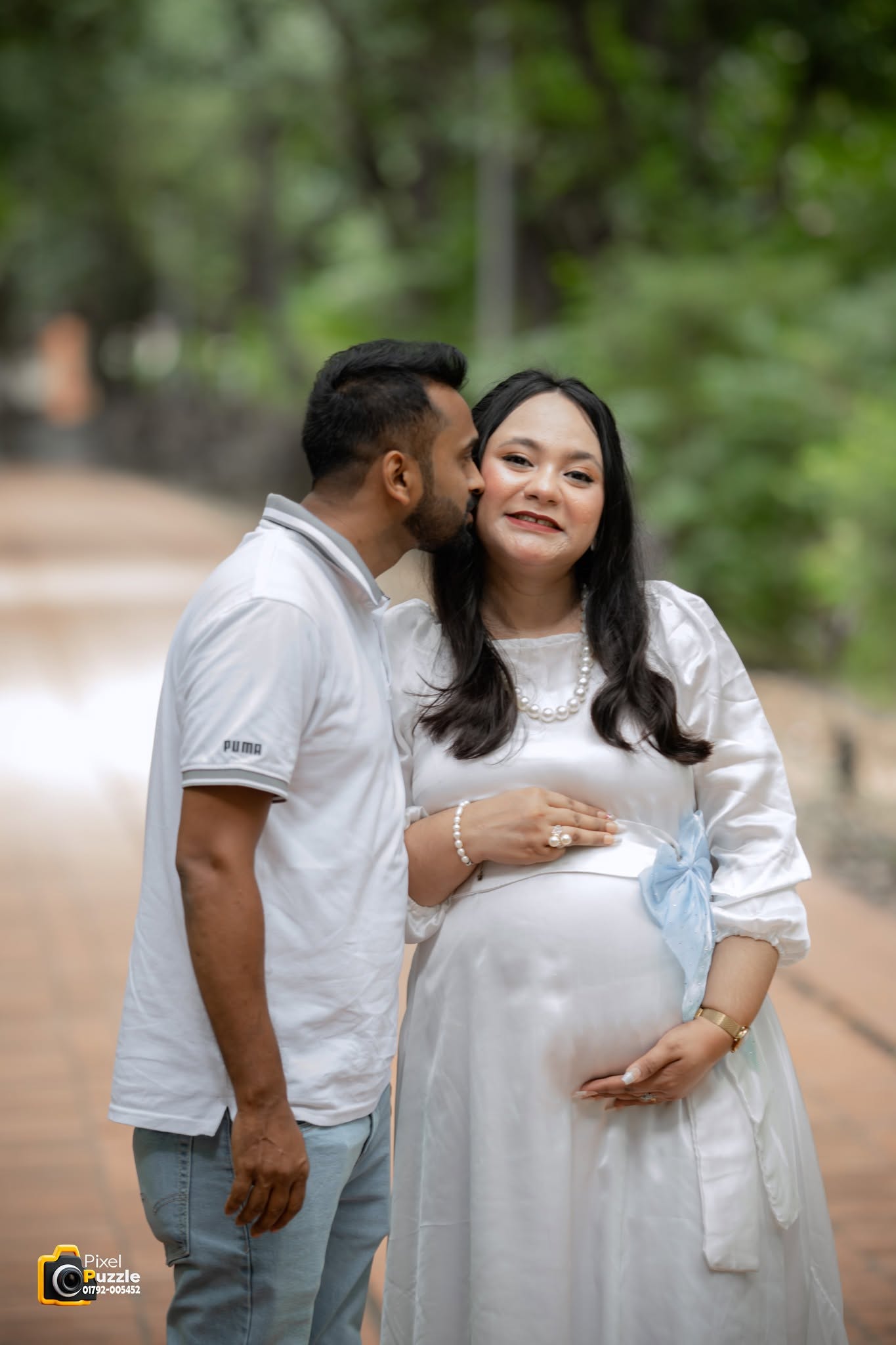 Expecting couple sharing a sweet outdoor maternity moment