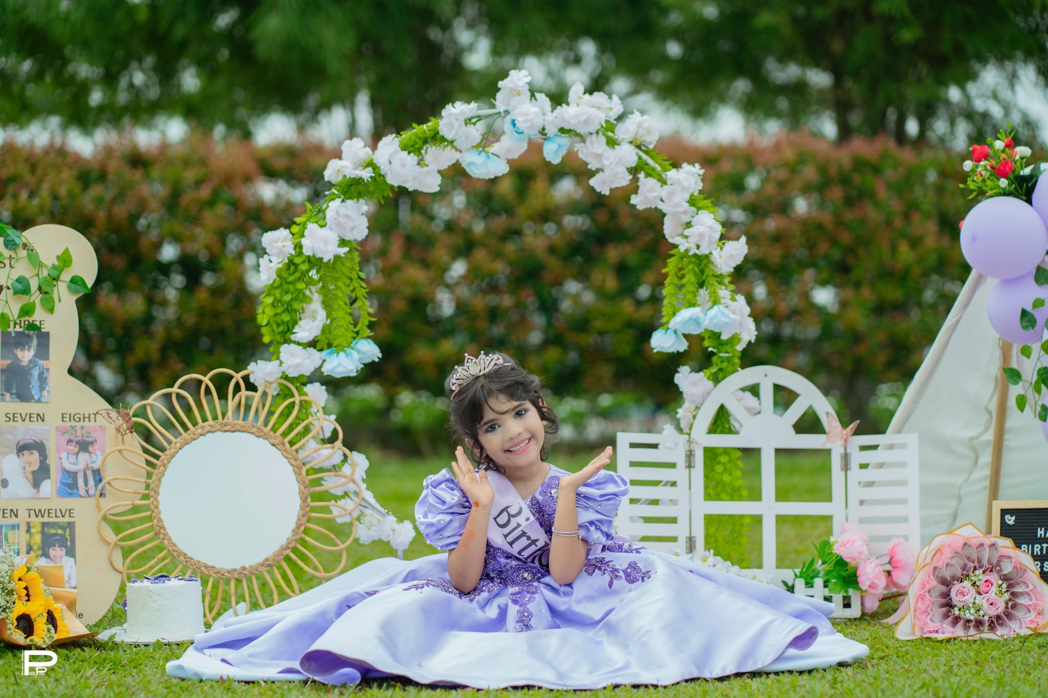 Outdoor birthday theme portrait with a purple princess setup